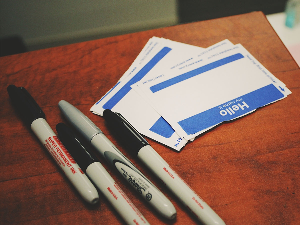 Image from: https://unsplash.com/photos/566CgCRSNCk Markers and name tags on a table